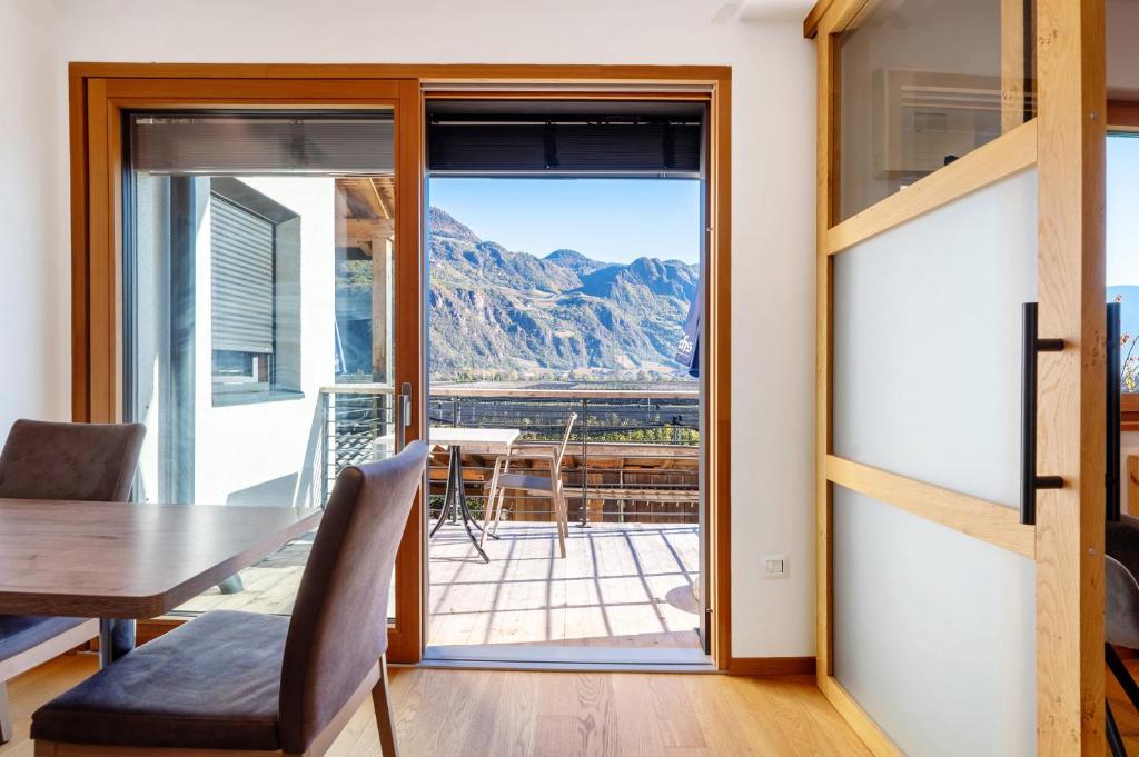 a dining room with a table and a view of a mountain at Ferienwohnung 3 Weger in Andrian