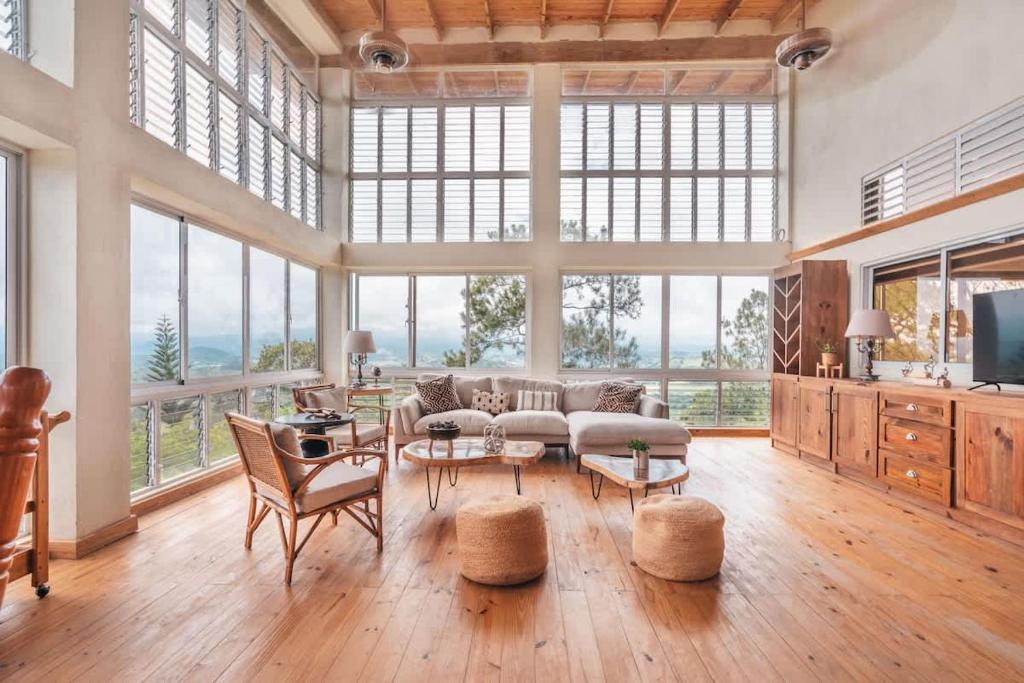 a large living room with a lot of windows at Stunning villa w pool & mountain view in Jarabacoa in Jarabacoa