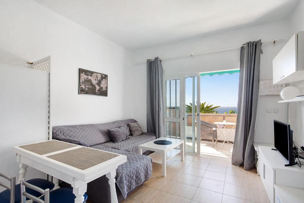 a living room with a couch and a table at Apartamento Cristobal in Morro del Jable