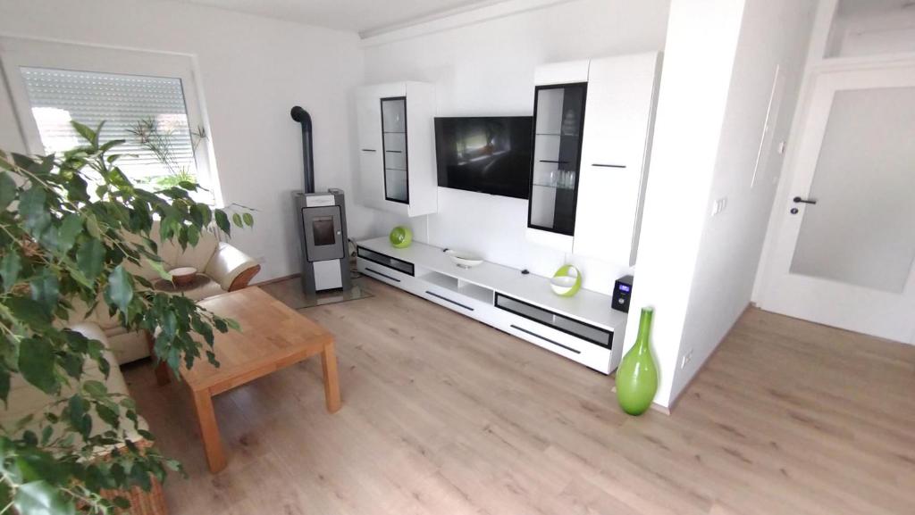 a living room with a tv and a couch and a table at Ferienhaus Kesper in Schottwien