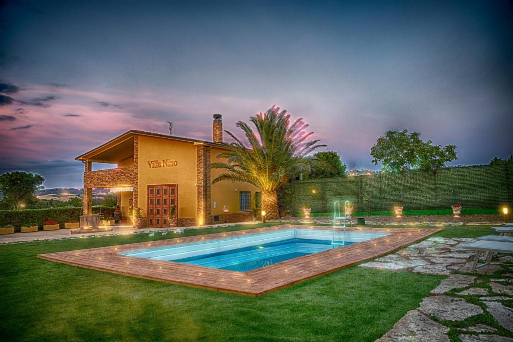 a house with a swimming pool in the yard at Villa Nino in Petacciato