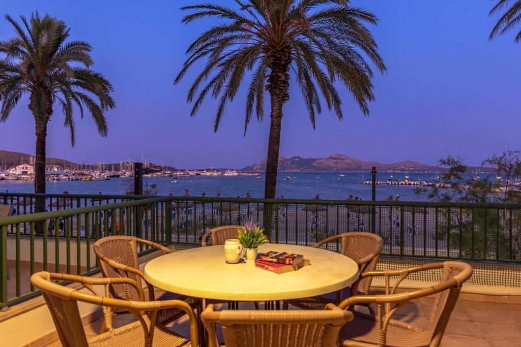 a table and chairs on a balcony with a view of the water at Daniela in Pollença