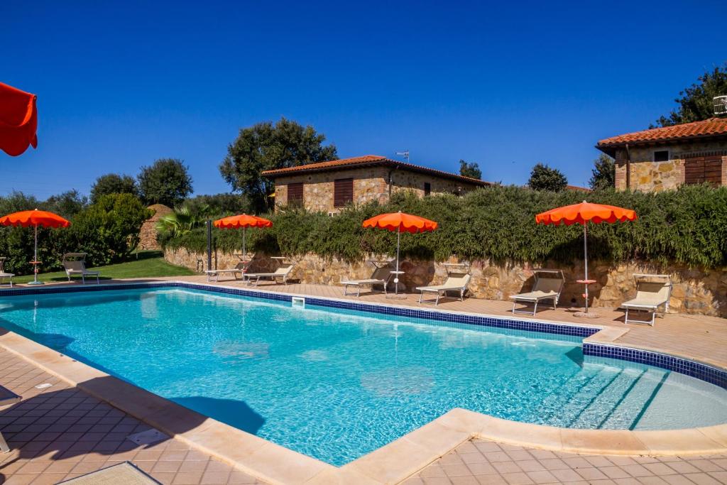 a swimming pool with chairs and umbrellas at Il Cancellone - Tartaruga in Montiano