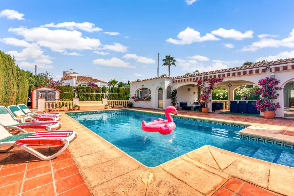 a swimming pool with a pink swan in a house at El Horreo Xabia in El Tosalet
