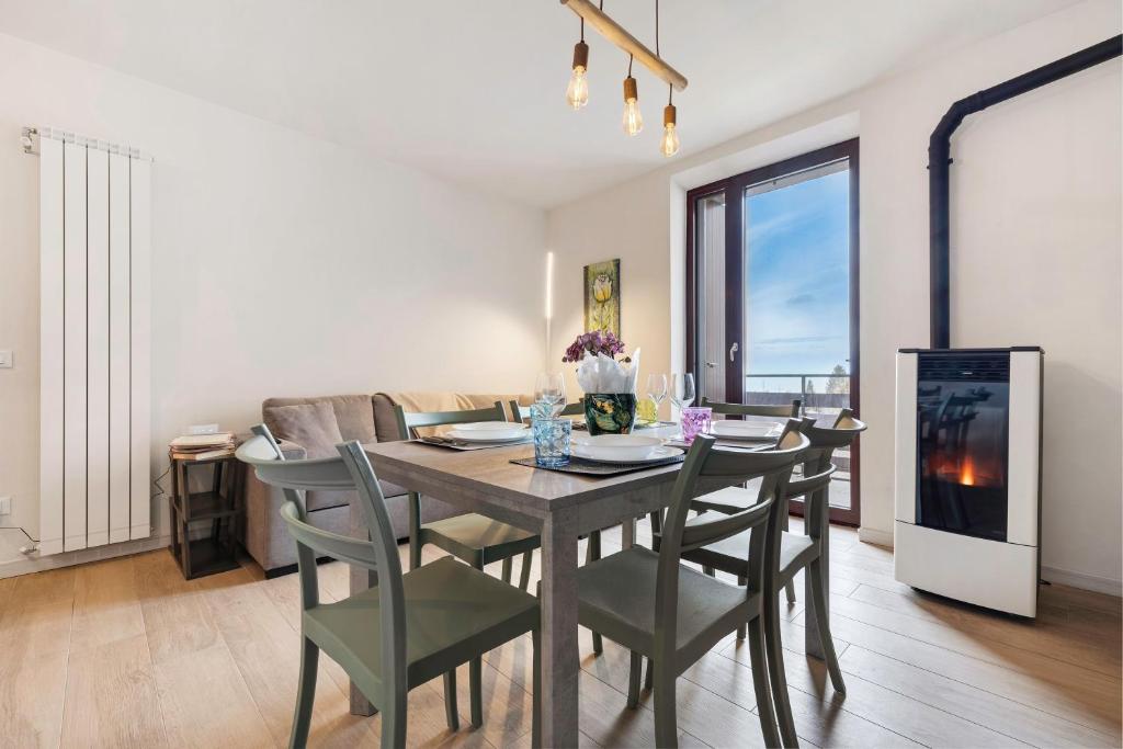 a dining room with a table and chairs and a couch at A Casa Mia Prada vacanza di relax in Prada