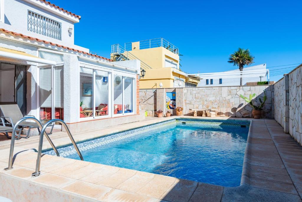 a swimming pool in the backyard of a house at Villa Monbijou in Vinarós