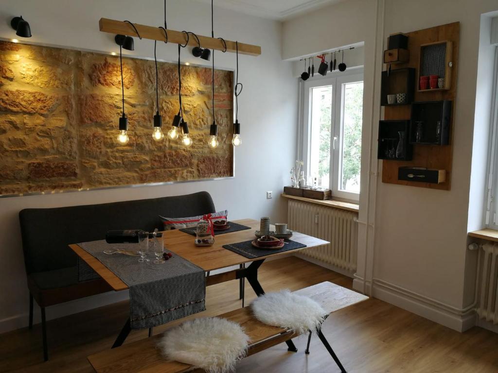 a dining room with a table and chairs and a dining roomiasm at Ferienwohnung Gugel, 48qm in Kandern