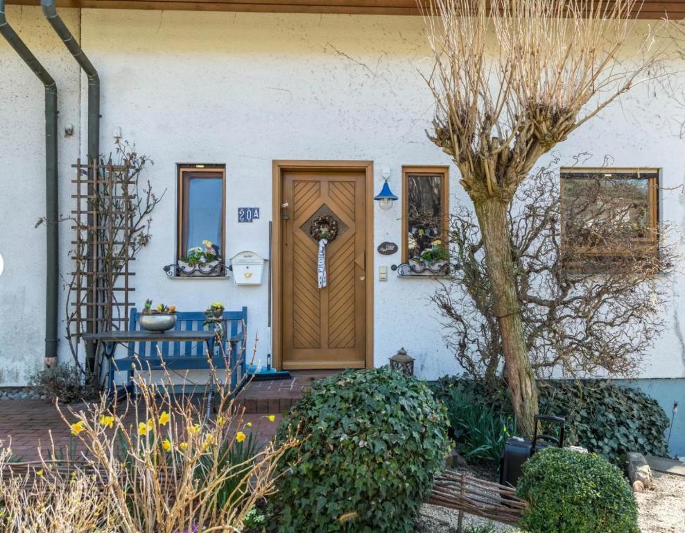 a house with a wooden door and a tree at Ferienwohnung Alina in Singen