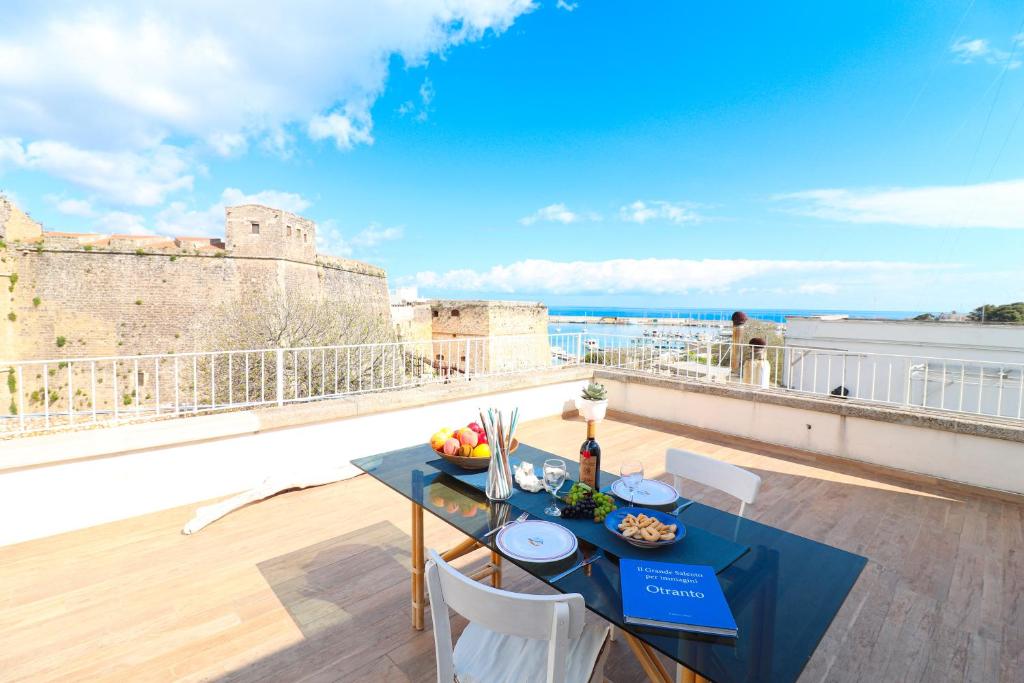a table and chairs on a balcony with a view at Casa Sveva a Otranto vista mare in Otranto