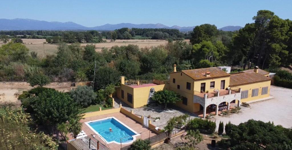 an aerial view of a house with a swimming pool at Les Cabretes Vilanova de la Muga in Vilanova de la Muga