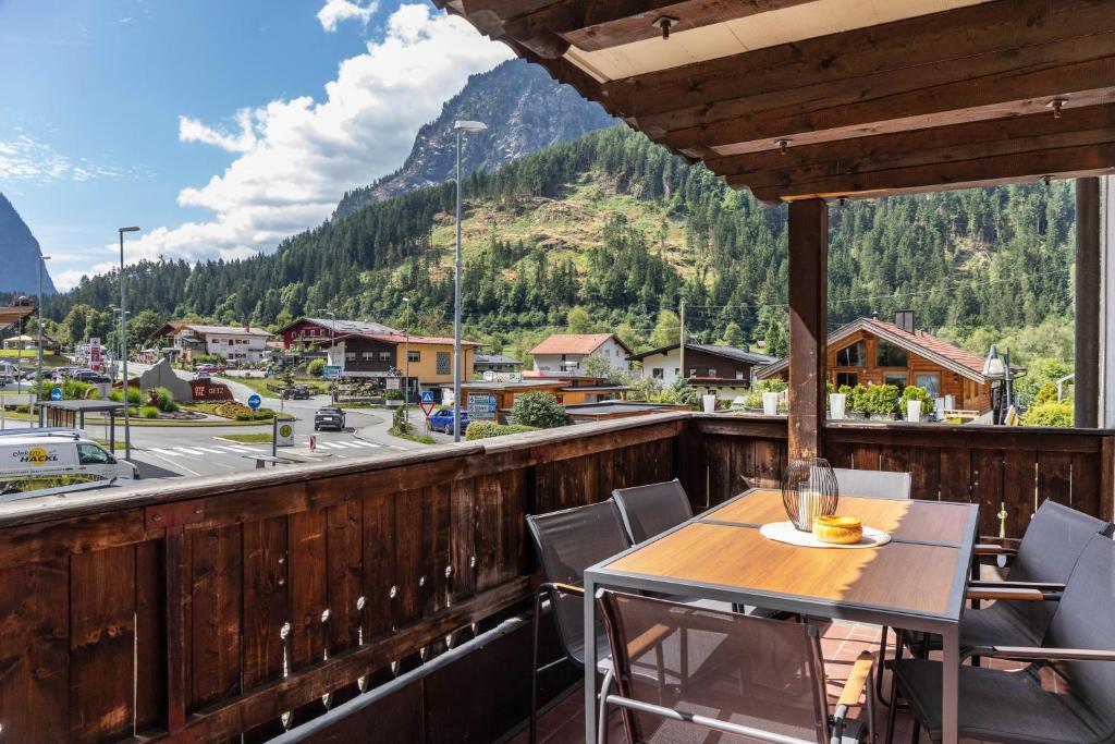 a table on a balcony with a view of a mountain at Apart Celina in Oetz