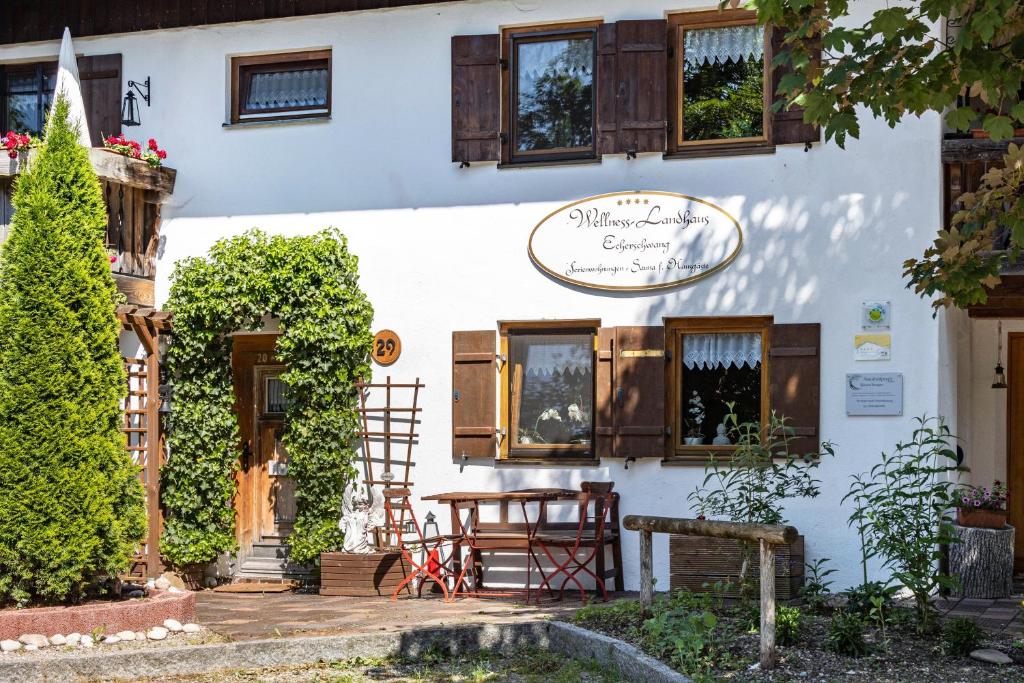 a building with a table and chairs outside of it at Landhaus Echerschwang in Bernbeuren