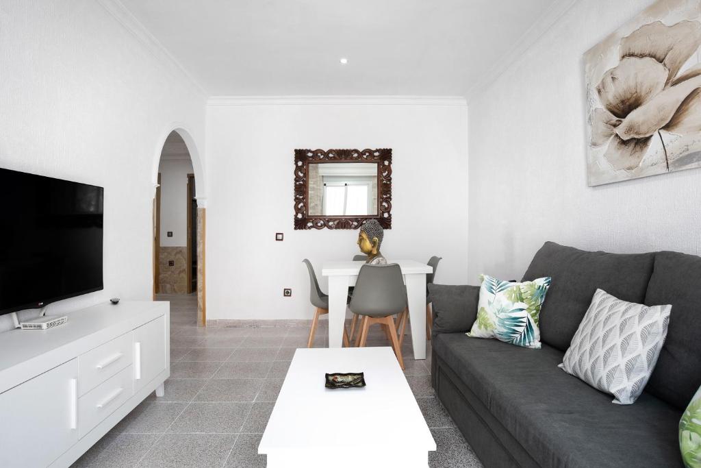 a living room with a couch and a table at Casa Unifamiliar Rio Barbate in Barbate