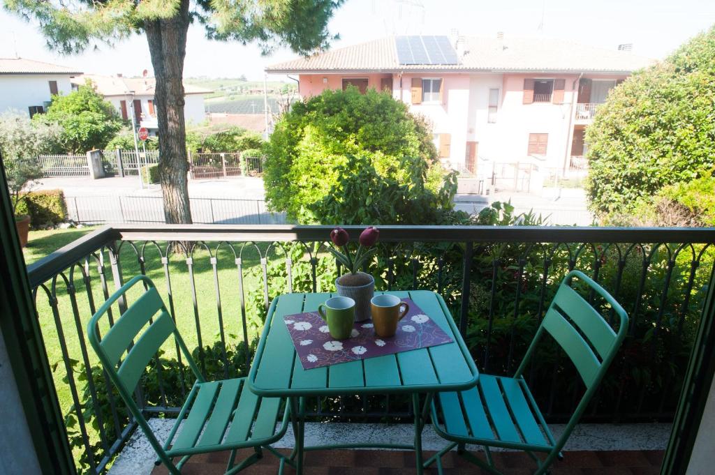 a table and two chairs on a balcony at Casa di Olly in Sona