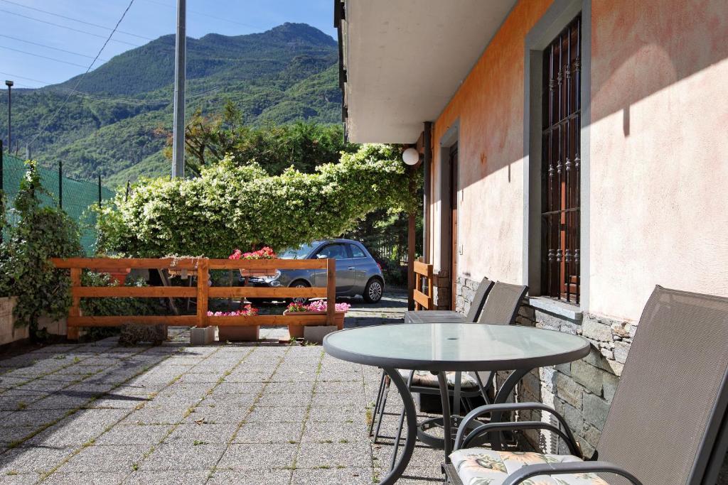 a patio with a table and chairs and a bench at Maison Chateau Chatillon in Châtillon