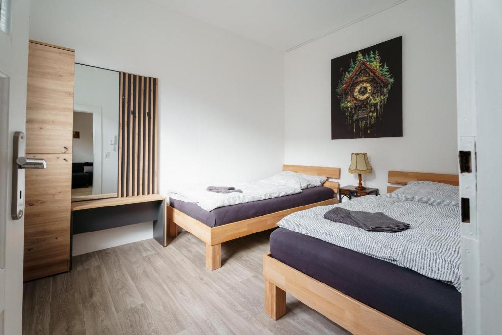 a bedroom with two beds and a mirror at Apartment 19 in Schutterwald