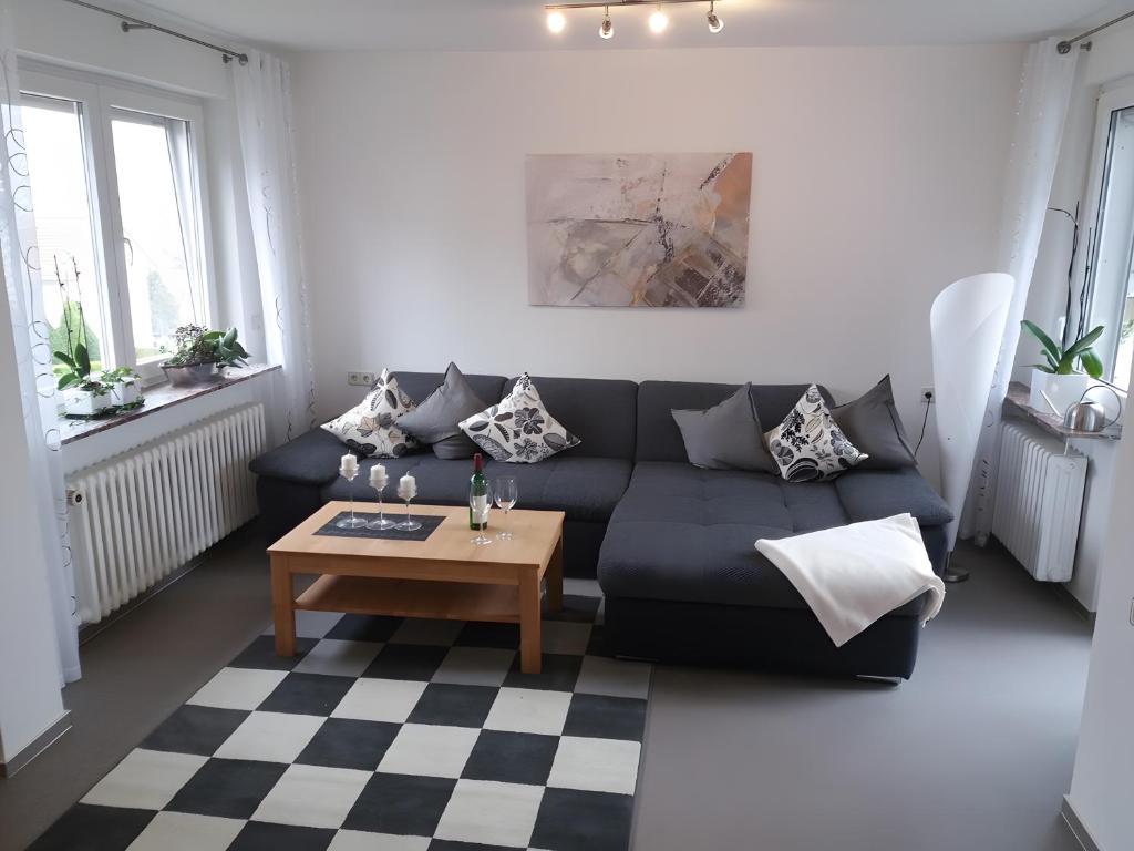 a living room with a black couch and a coffee table at Haus Maruna in Schauenburg