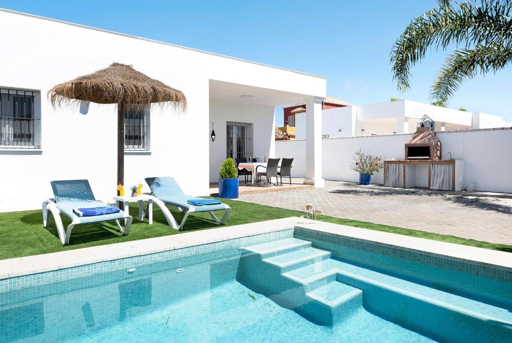 a villa with a swimming pool and a house at Casa Orilla Sur B in El Palmar