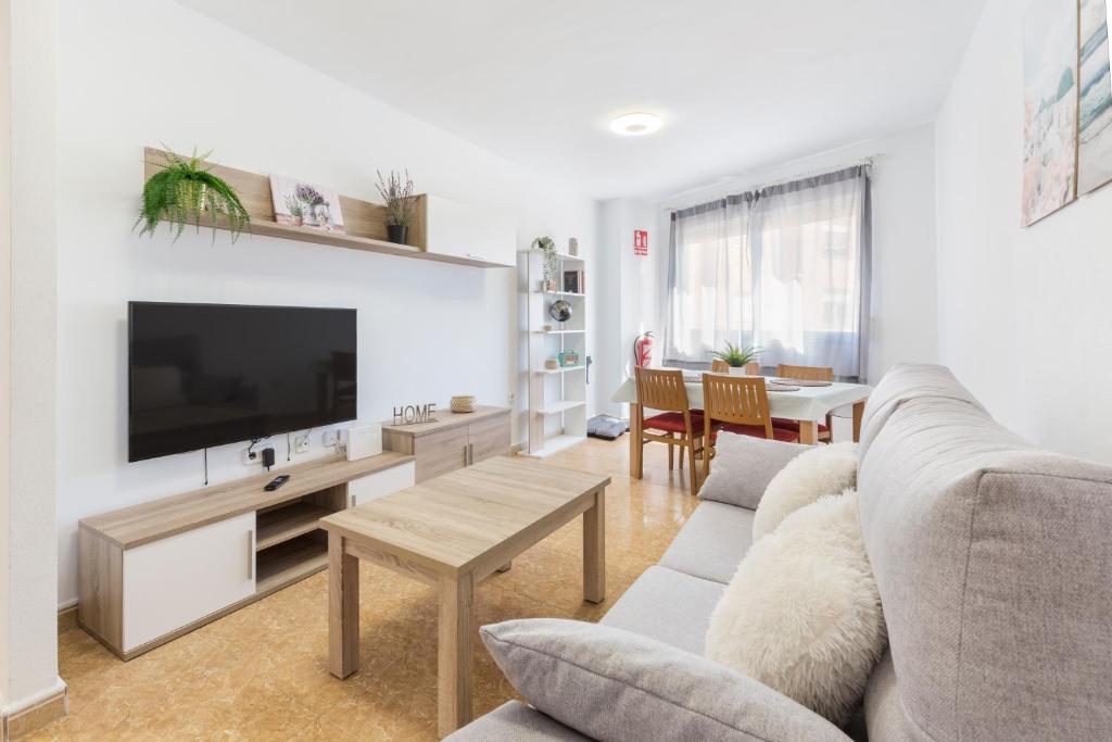 a living room with a couch and a flat screen tv at Vivienda maiva in Alhama de Murcia