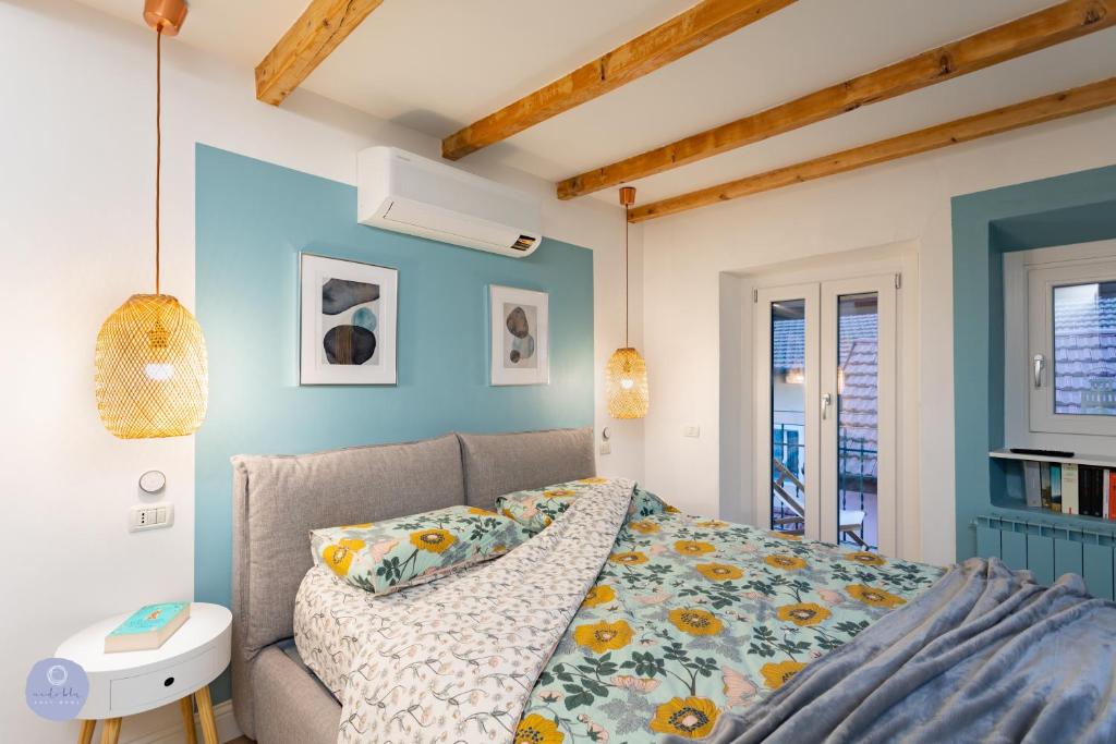 a bedroom with a bed and a blue wall at Nido Blu - Vista Lago in Belgirate