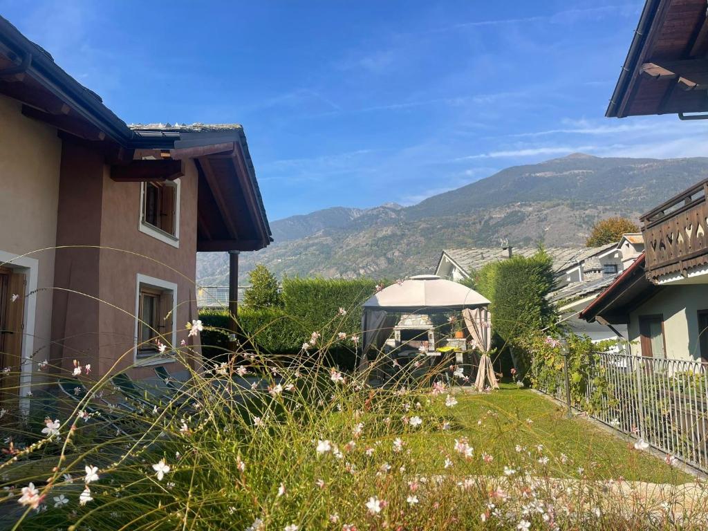 a gazebo in the yard of a house at Au Petit Chevrot - Garden in Aosta