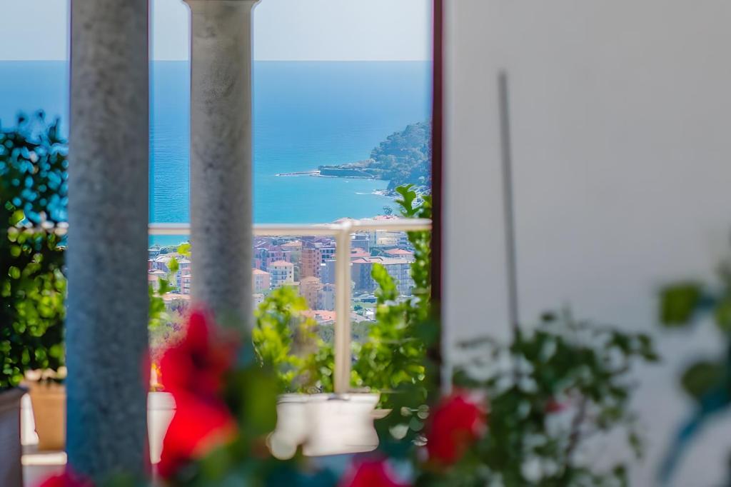 a view of the ocean from a window at Villetta Antonia in Marina di Andora