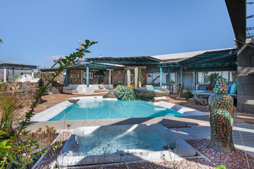 a house with a swimming pool in a yard at Villa Dafmir in Tías