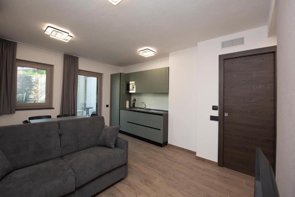 a living room with a couch and a kitchen at Appartamenti Suly 5 - Cir 0086 in Saint Vincent