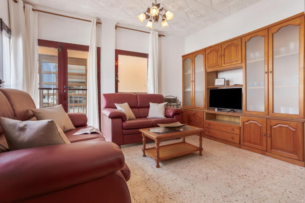 a living room with two couches and a tv at Casa Abuela Maruca in Corralejo