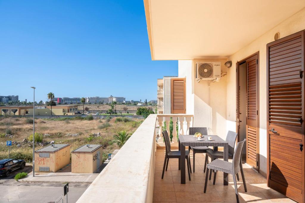 a balcony with a table and chairs on it at Casa Manuela in Lecce