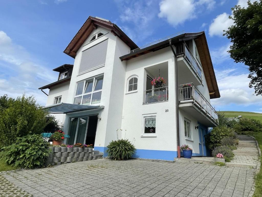 a white house with a window and a balcony at Ferienwohnung - Haus Waibel in Überlingen