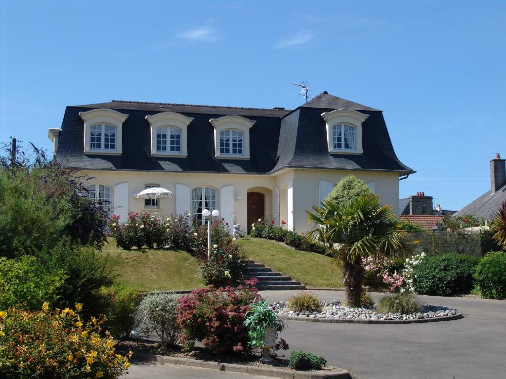 a large white house with a black roof at La Mansardière in Cancale