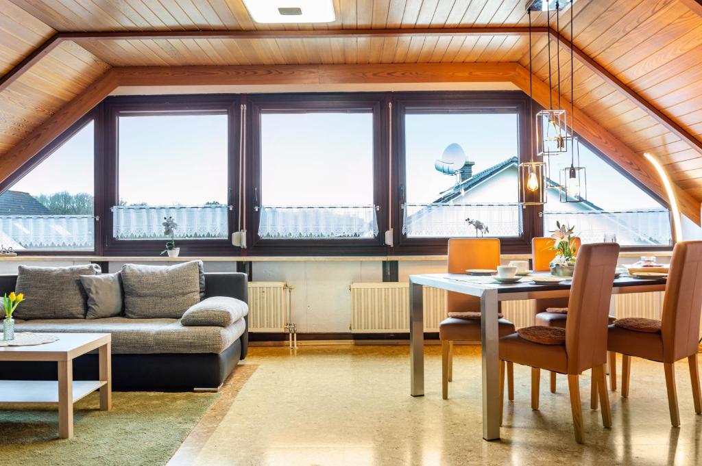 a living room with a table and a couch at Fewo Naturblick in Wiesenthau