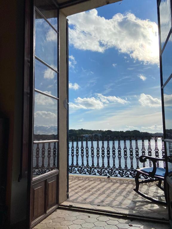 an open door to a balcony with a view of the water at Casa vacacional Es Port in Portocolom