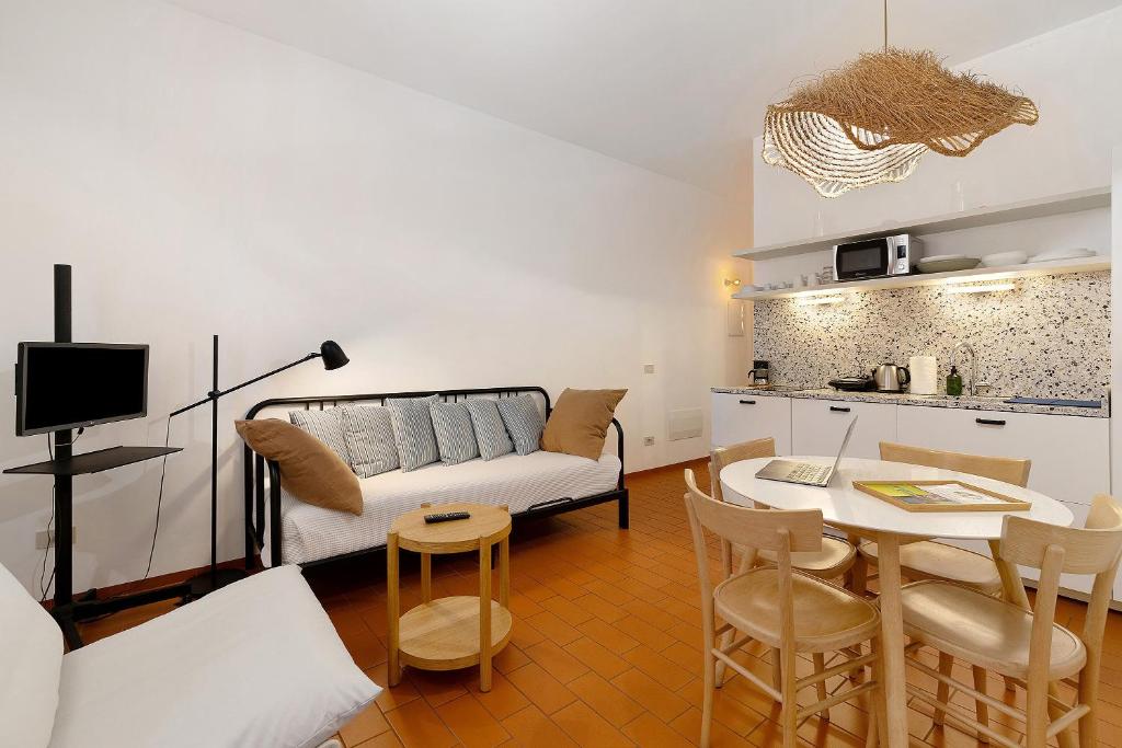 a living room with a couch and a table at U Canetta 1 in Pietra Ligure
