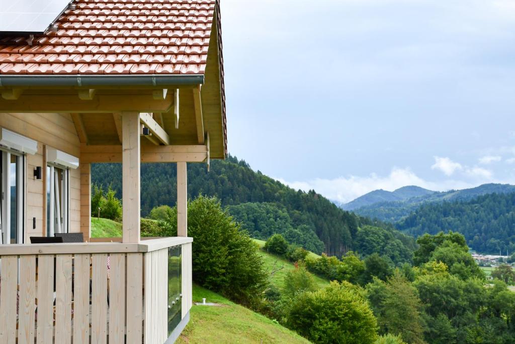 a house on a hill with mountains in the background at Panoramahisli 3 in Fischerbach