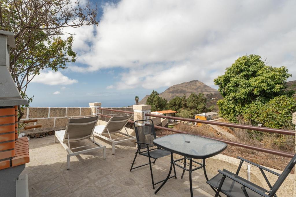 a patio with chairs and a table and a view at La Generosa in Arona