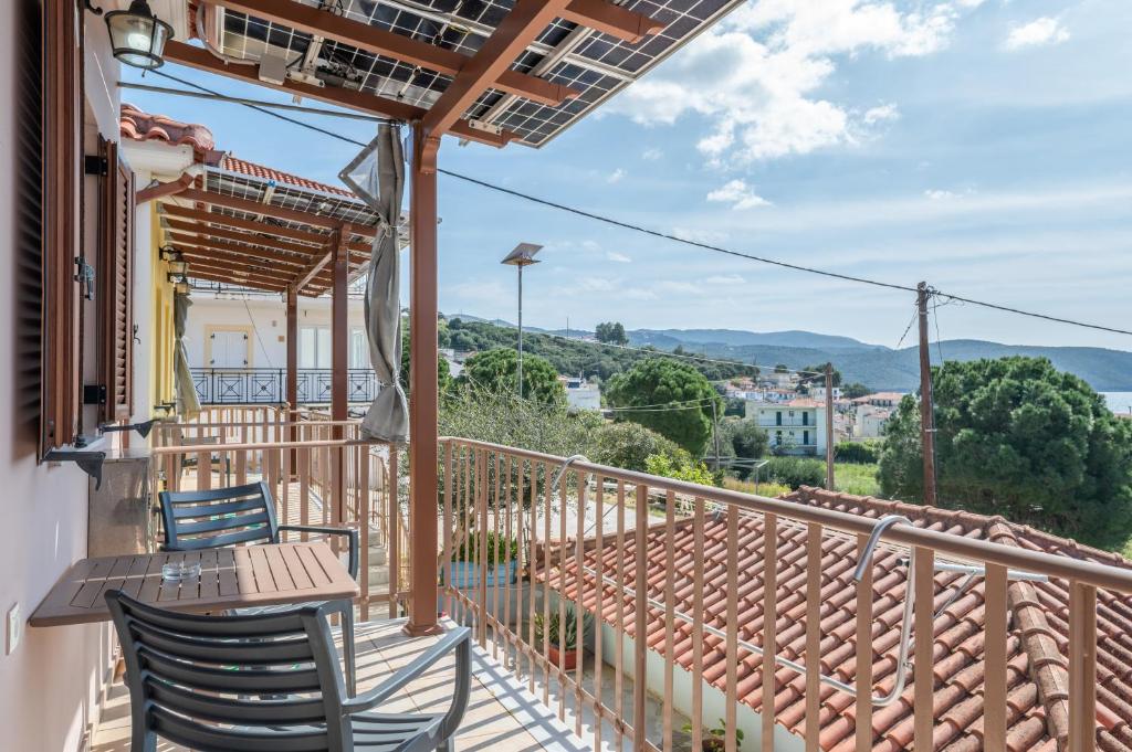 a balcony with chairs and a table and a view at Chroma Finikounda 2 in Finikounta