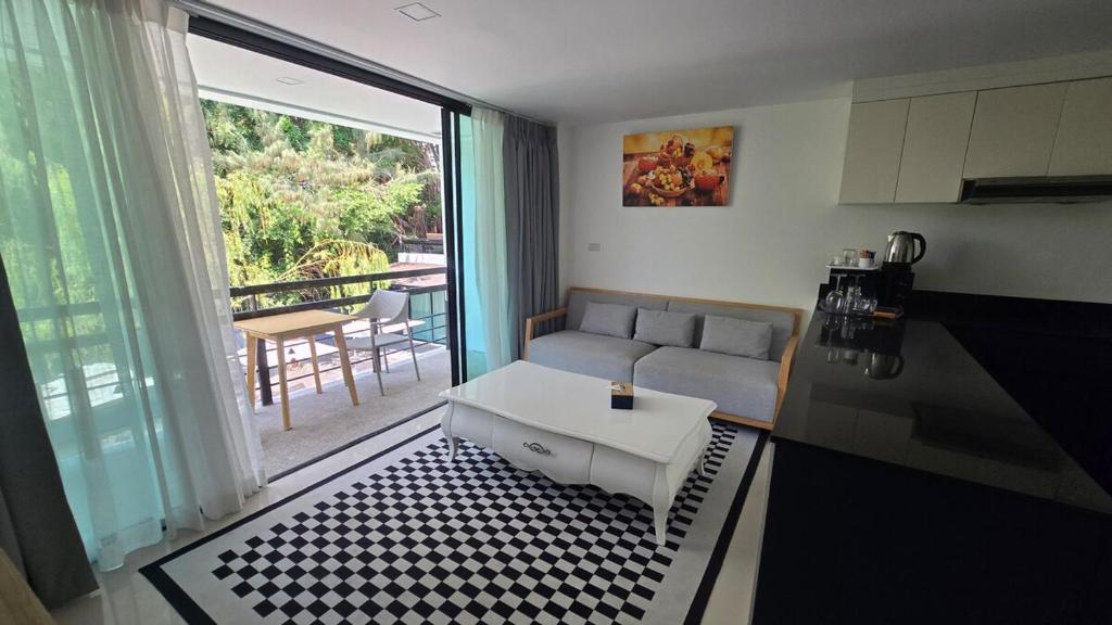a living room with a couch and a table at joyful theKrisA205 in Ban Lum Fuang