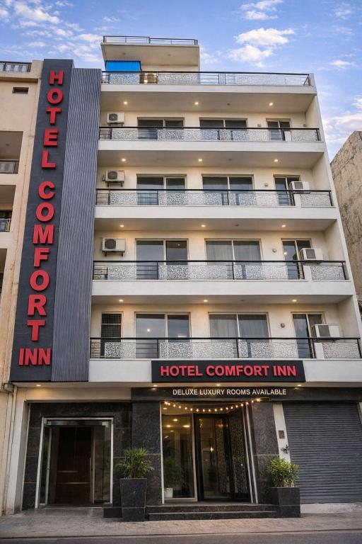 a hotel with a hotel contract inn sign in front of a building at Hotel Comfort Inn, Nangloi, Walking from Metro in New Delhi