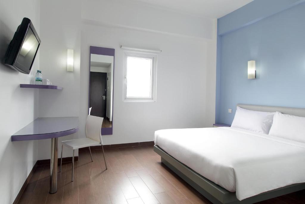 Postel nebo postele na pokoji v ubytování Amaris Hotel Pekanbaru