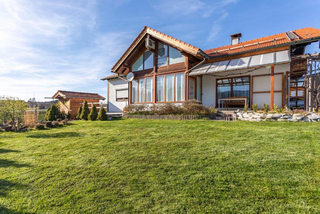 a large house with a grass yard at Haus Kali in Teisendorf