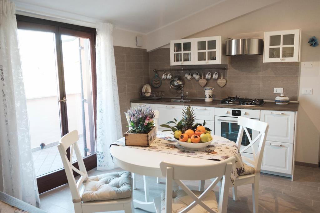 una cocina con una mesa con un bol de fruta. en Temporary Home Dragonara, en San Giovanni Teatino