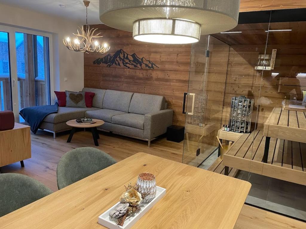a living room with a couch and a table at Tauplitzrausch Lodge in Tauplitz