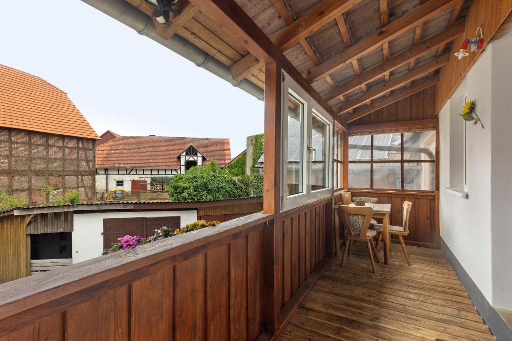 an outdoor deck with a table and chairs at Ferienwohnung Sonnenblume in Rhadern
