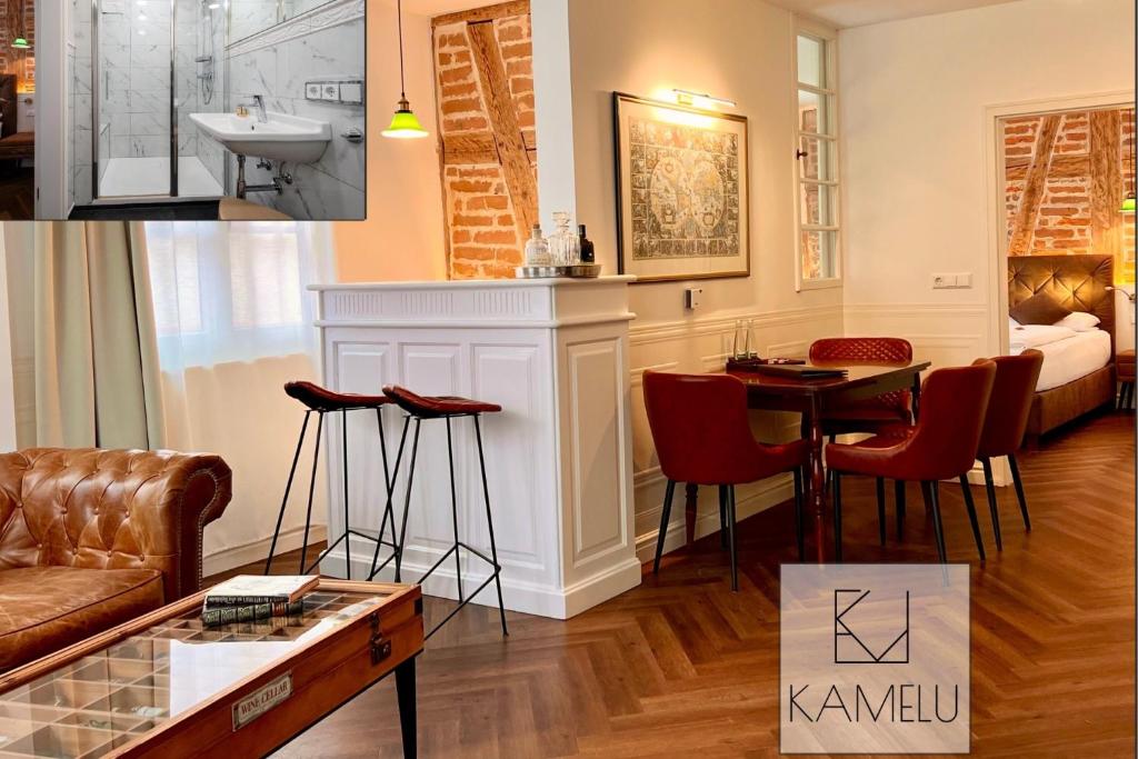 a living room with a couch and a table at Boutique Suites anno 1789 by Kamelu in Gengenbach