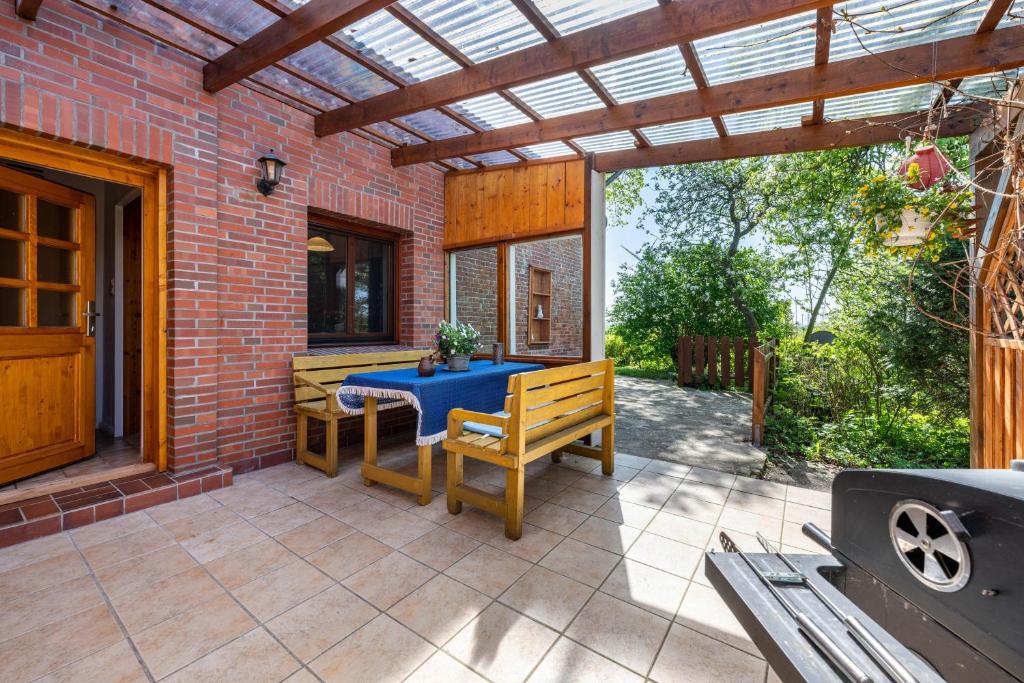 a patio with a blue table and a bench at Ferienhaus Himmelreich in Barlt