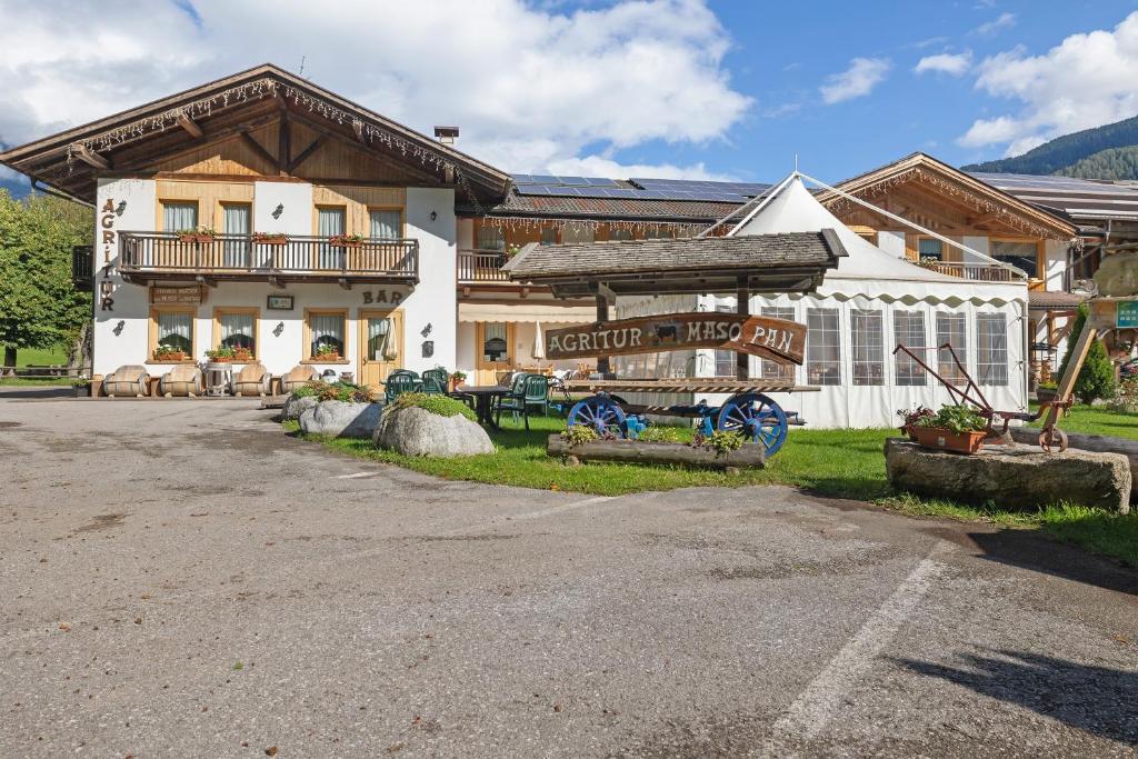 a building with a sign in front of it at Agritur Maso Pan in Caderzone Terme