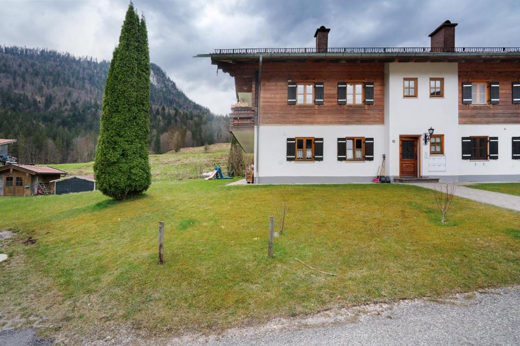 a large house with a grassy yard in front of it at Place In The Bavarian Mountains in Schneizlreuth