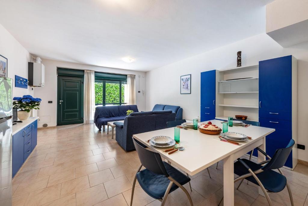a kitchen and living room with a table and chairs at Nice apartment Le Vele Garda Lake in Toscolano Maderno